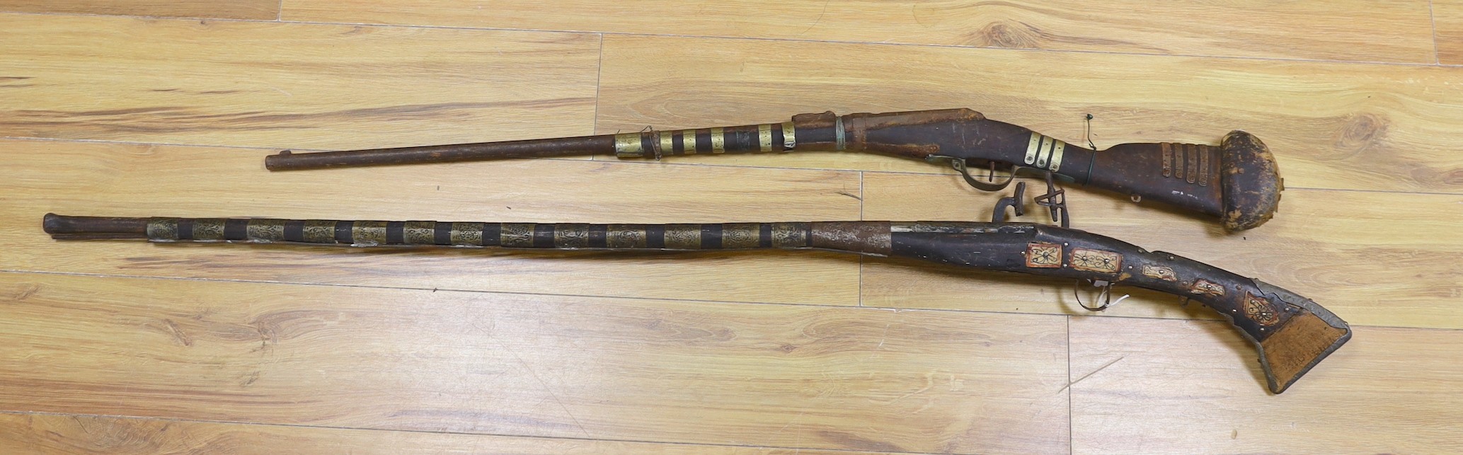 Two 18th century continental long arm rifles, longest 143 cms.